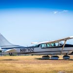 Cessna 205 N8170Z left rear low angle view showing fixed landing gear and wheel pants