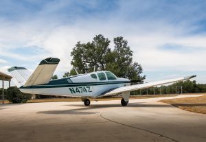 Rear three-quarter view of N474Z, a 1957 Beechcraft H35 Bonanza
