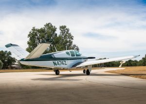 Rear three-quarter view of N474Z, a 1957 Beechcraft H35 Bonanza