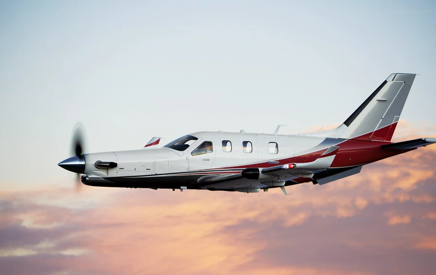 Daher TBM single-engine turboprop in flight at sunset